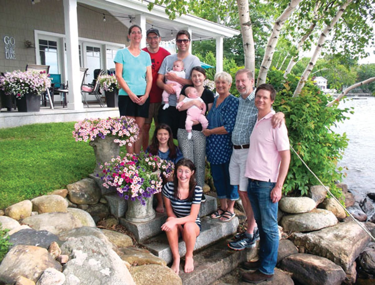WITH THE FAMILY: Martin “Marty” Podskoch is pictured at his home on Lake Pocotopaug in East Hampton, Connecticut, with members of his family. Seated are Lydia and Kira Roloff, and standing, left to right, are Kristy and Matt Roloff, Ryan and Jenna with Lily Ann and Anna Lee Podskoch, Lynn, Marty and Mattew Podskoch.